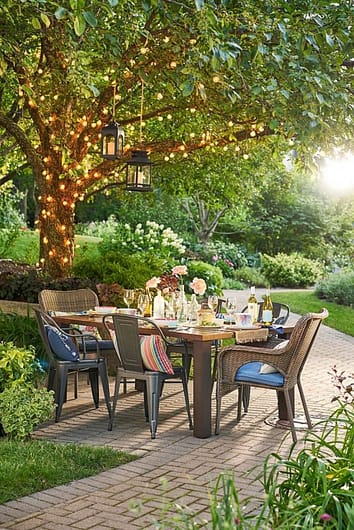 Gentle lighting adds a level of intimacy to an outdoor dining area 